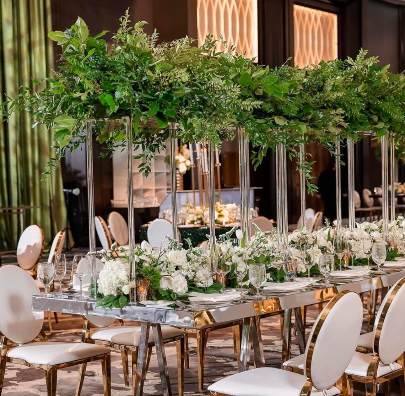 Luxury greenery table arrangement with tall centerpieces